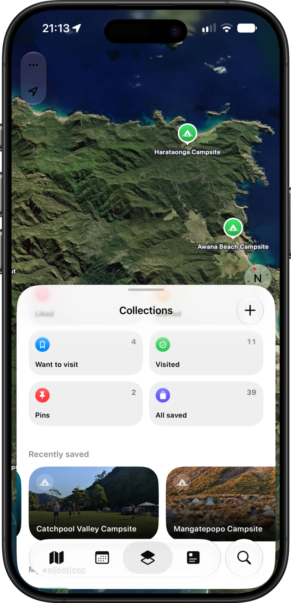 The KiwiCamping collections screen with Want to visit, Visited, Pins and All saved lists over a satellite map of Great Barrier Island
